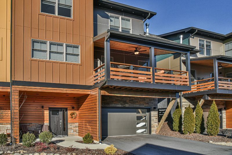 A row of houses with a garage and a balcony.