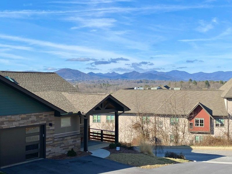 A row of houses with mountains in the background