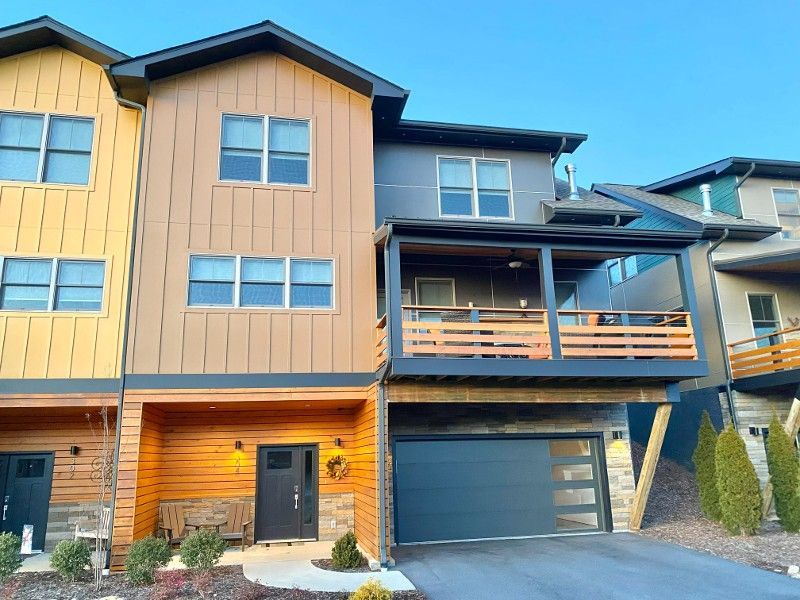A large house with a large garage and a balcony.