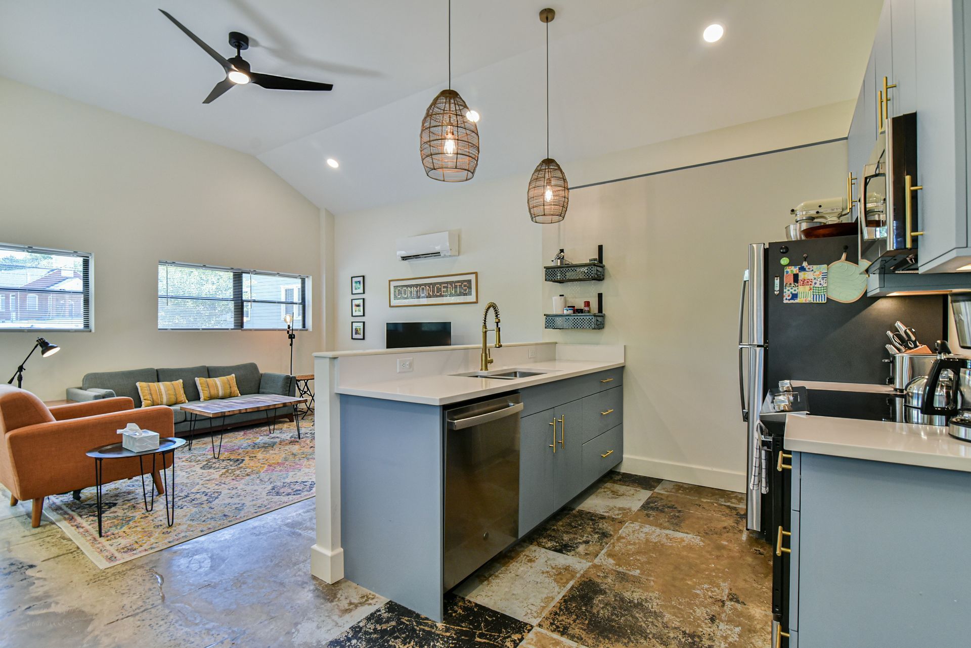 Cozy café counter with two stools, pendant lights, and a large window overlooking greenery