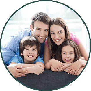 Smiling family of four leaning on a couch, framed by a blue circular border
