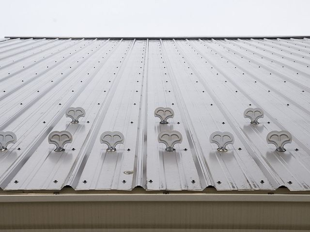 A metal roof with snow stoppers on it