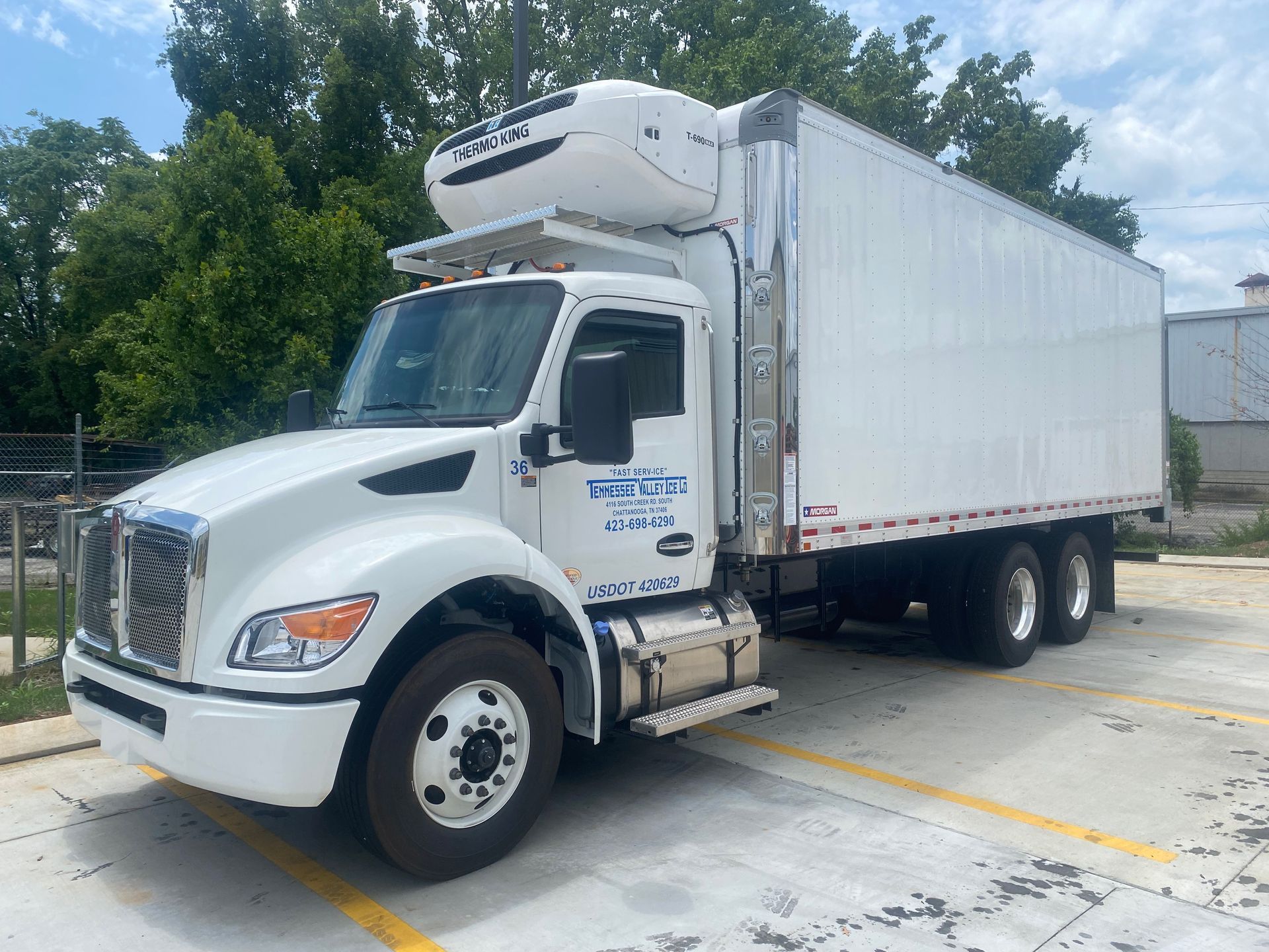 White refrigerated box truck parked outdoors.