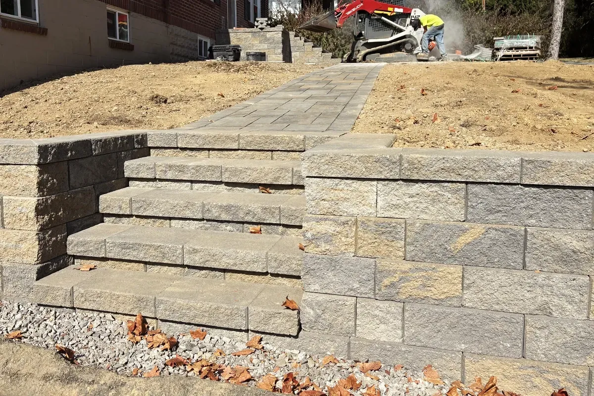 Exterior of brick building with small trees and rock landscaping.