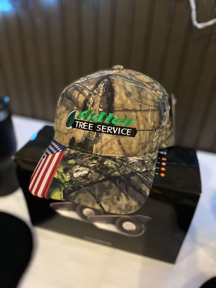 A hat with the word tree service on it is sitting on a table.