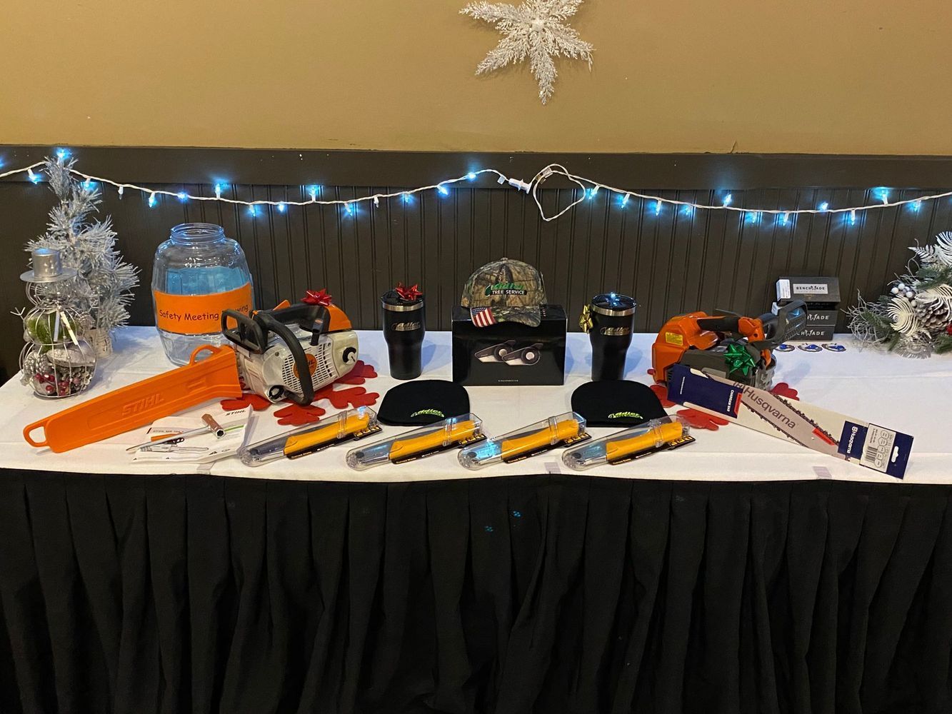 A table with a lot of tools and a chainsaw on it.