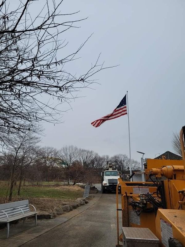 An american flag is flying in front of a truck