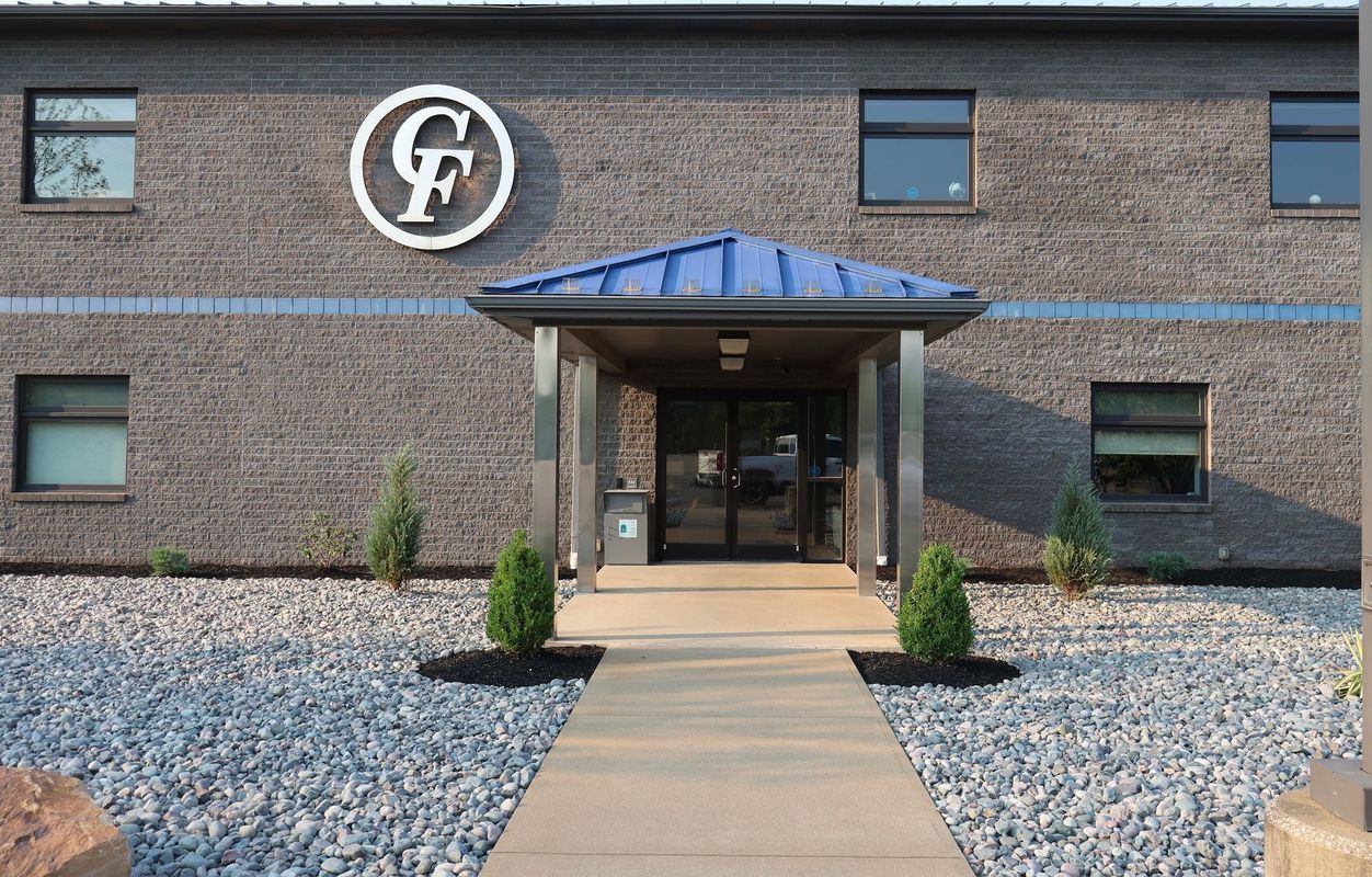 A brick building with a sign that says gf on it