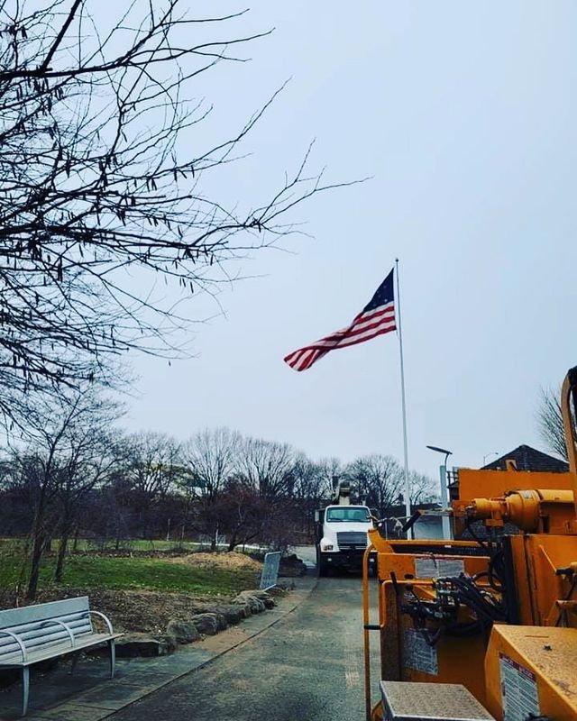 An american flag is flying in front of a truck