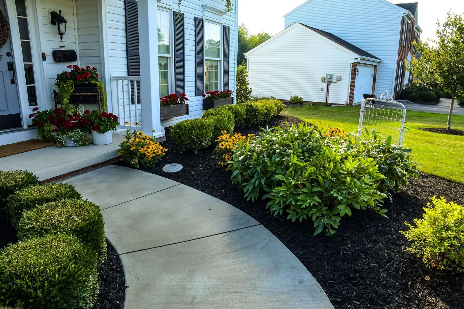 A white house with a walkway leading to it