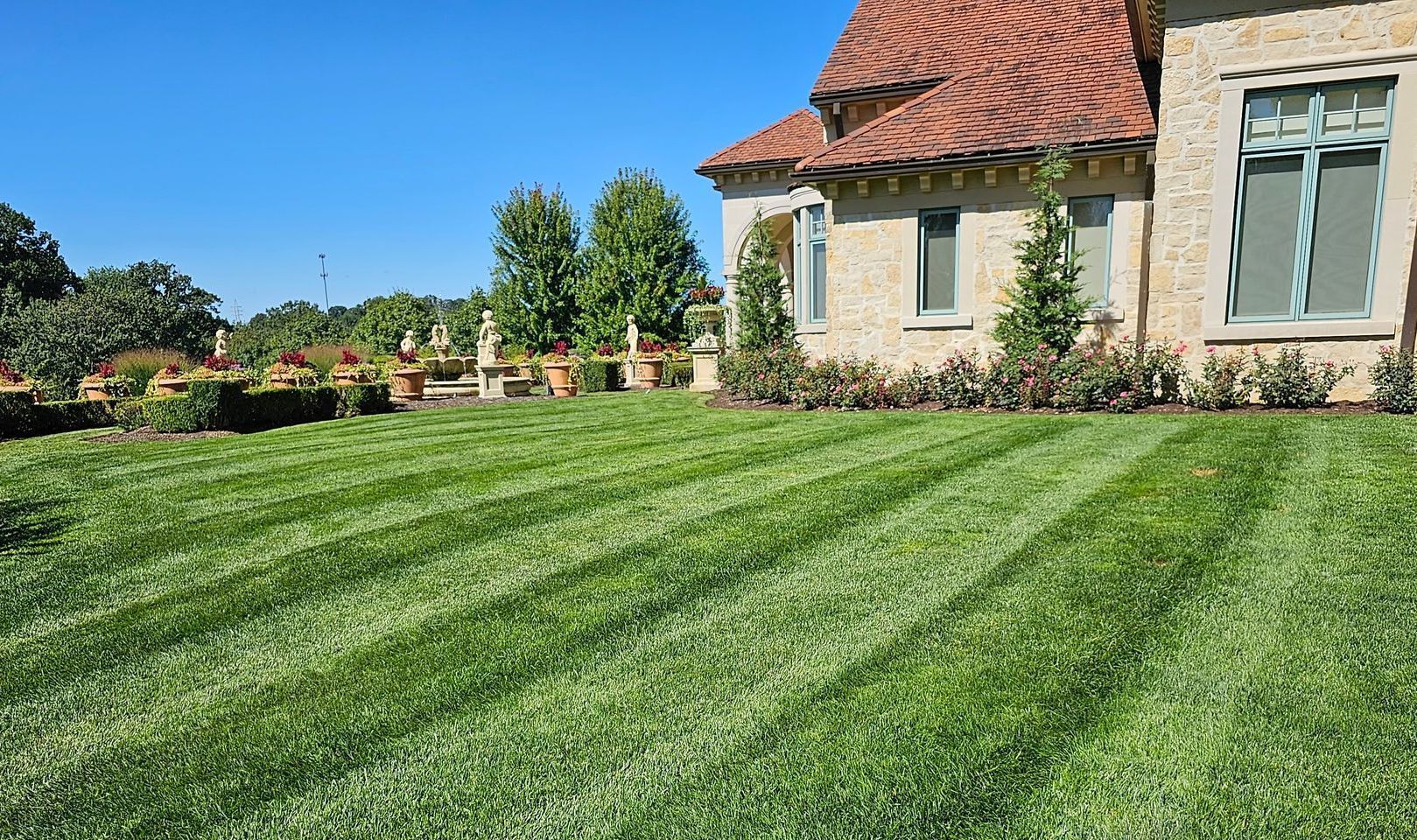 A house with a lush green lawn in front of it.