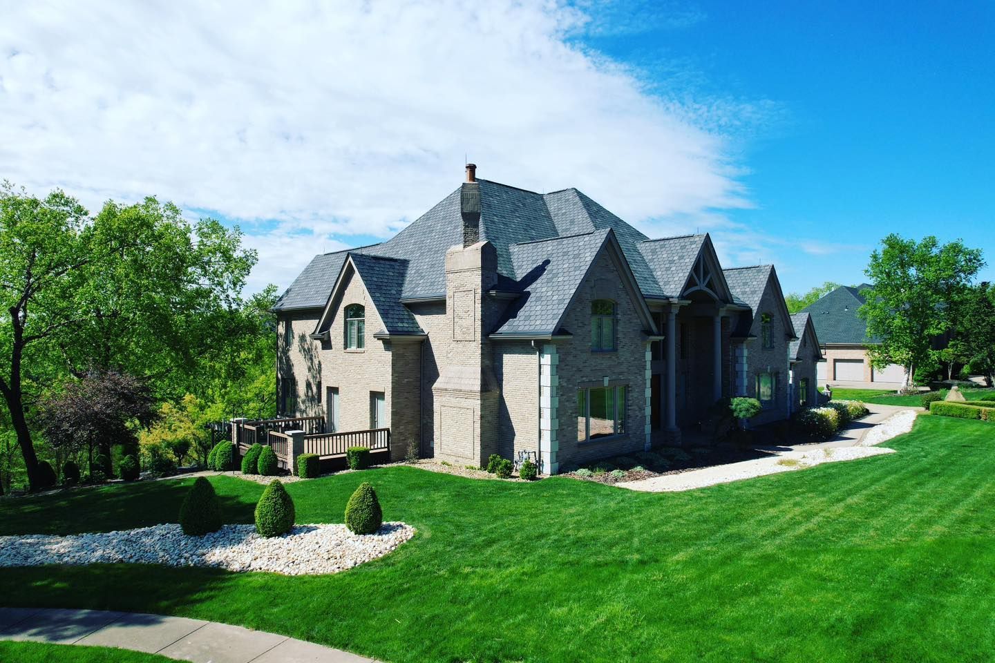 A large house with a lush green lawn in front of it.