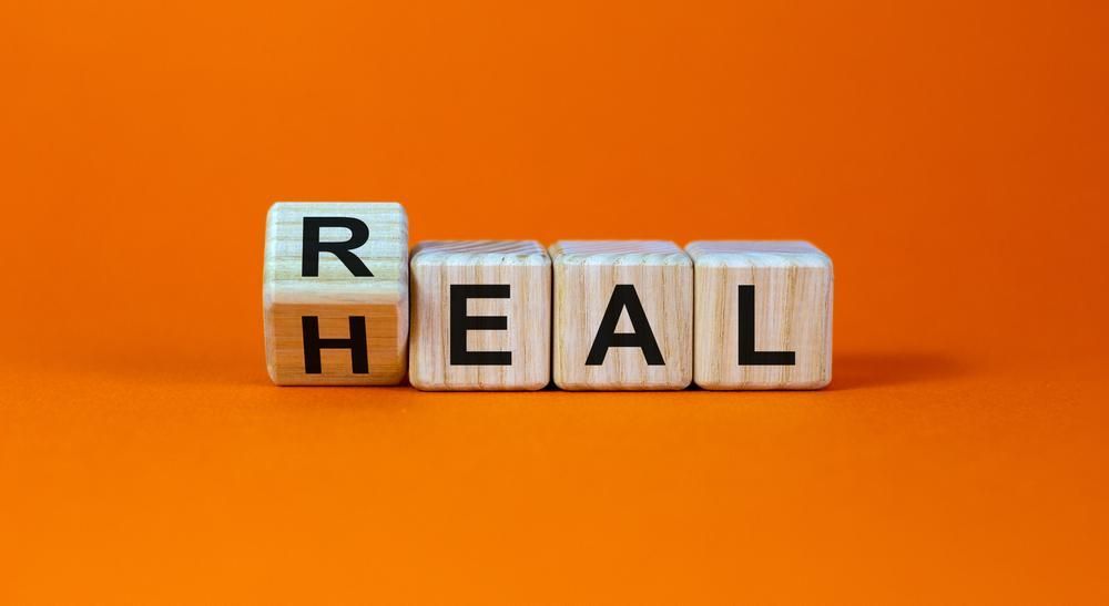 Letter blocks spelling “RHEAL” on an orange background
