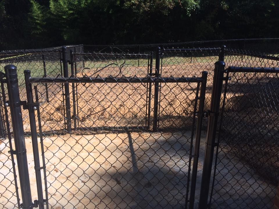 A chain link fence with a gate in the middle of it