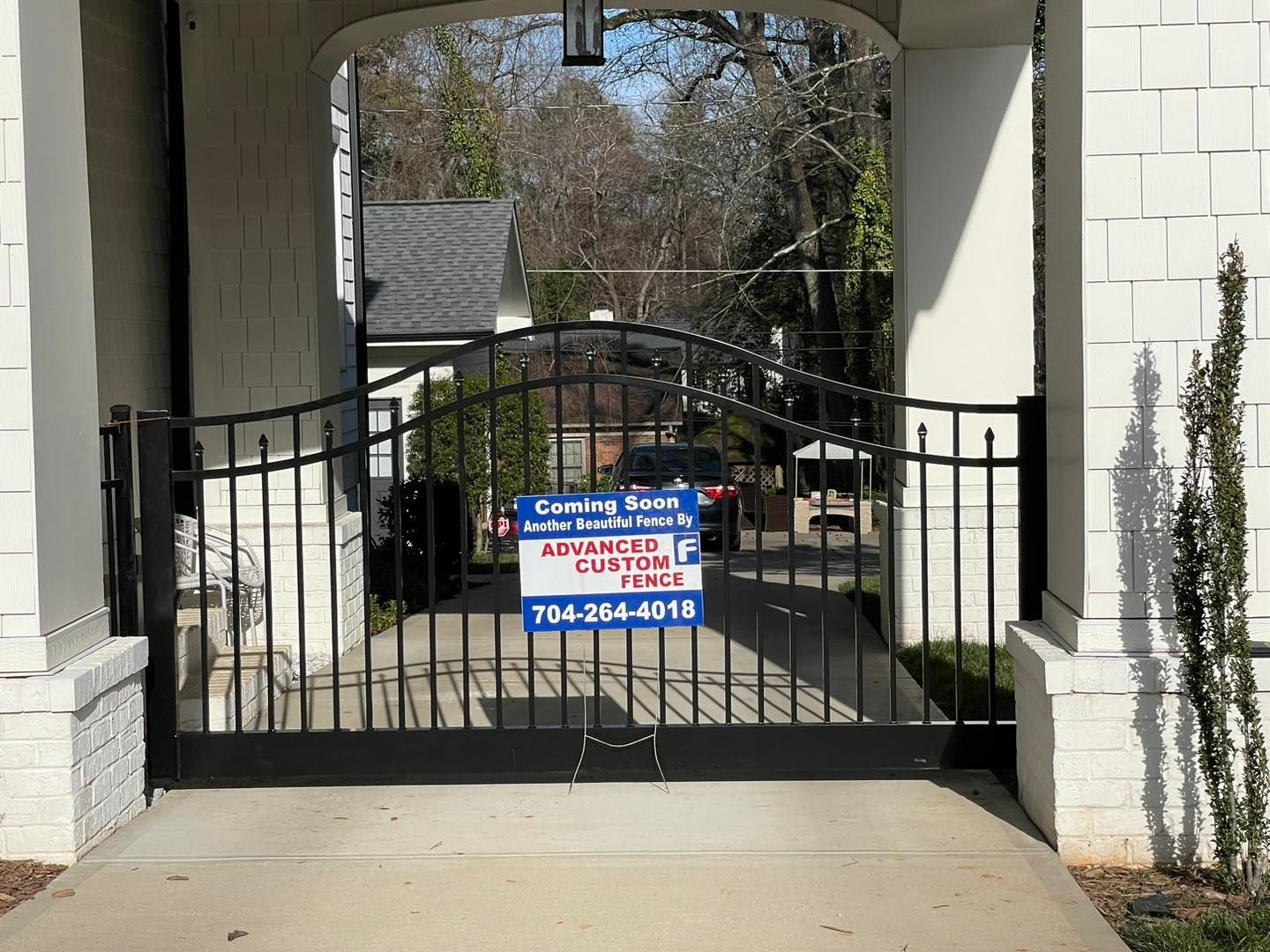 A wrought iron gate with a sign on it that says advanced security