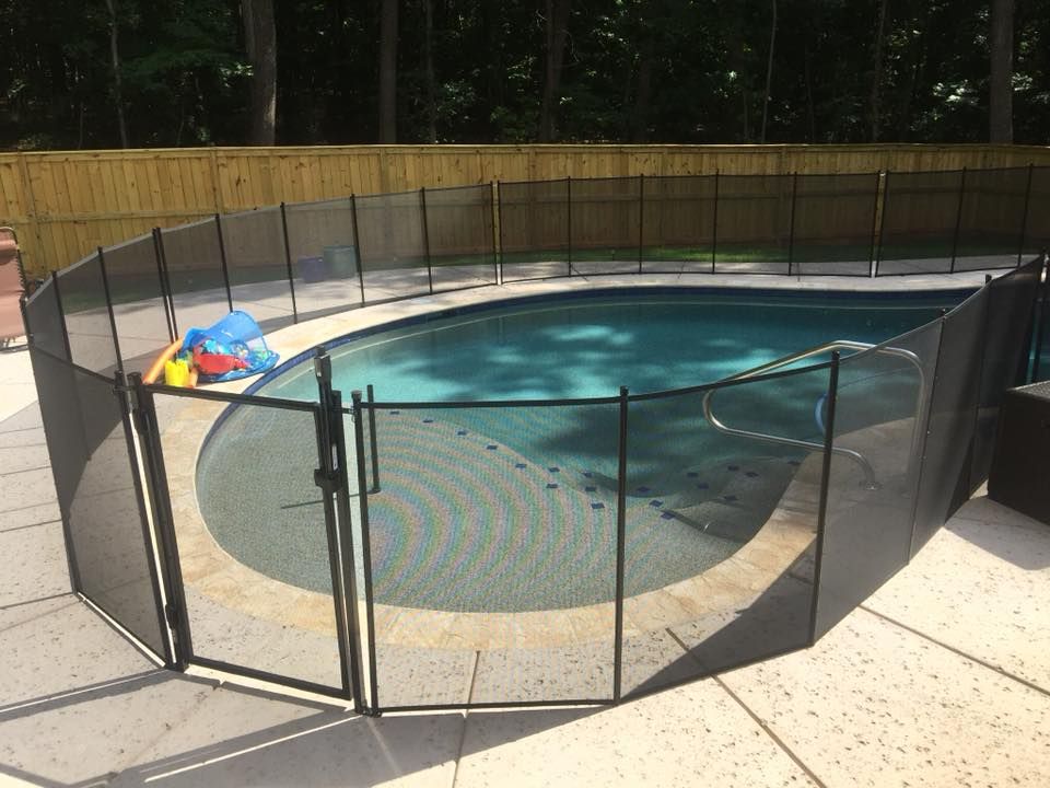 A large swimming pool with a fence around it