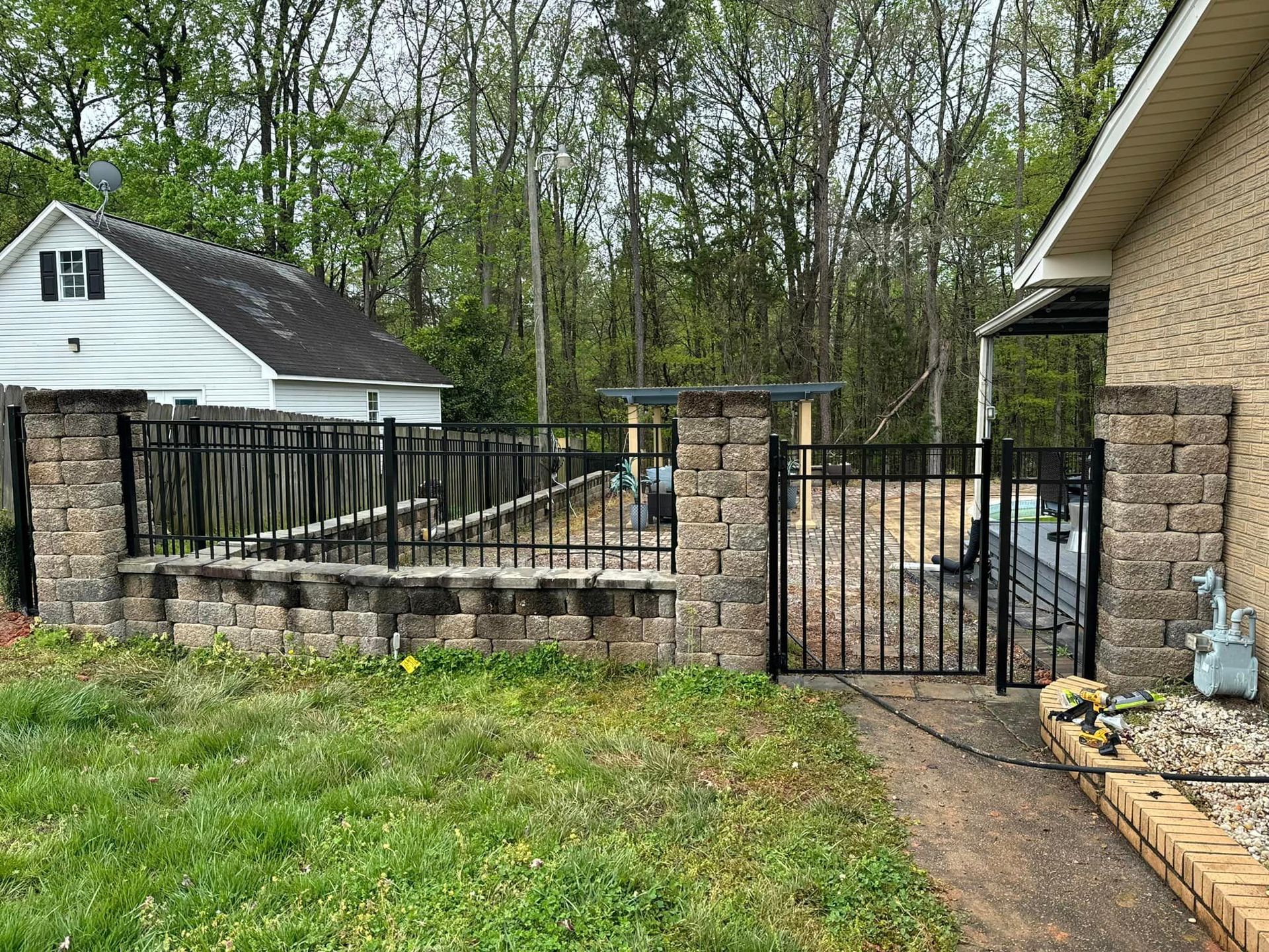 A house with a fence and a gate in front of it.