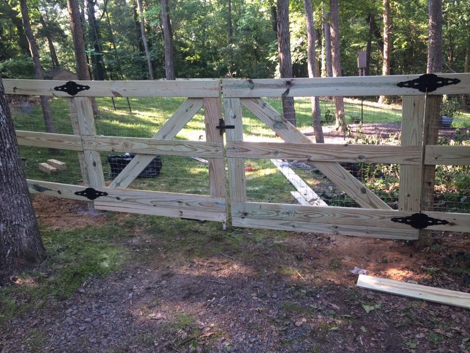 A wooden fence is being built in the woods.