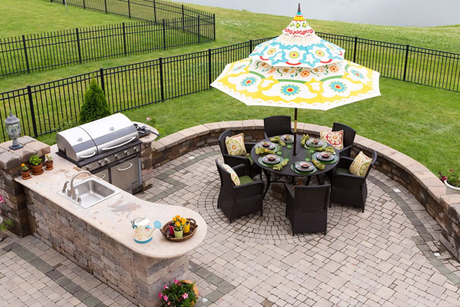 An aerial view of a patio with a table and chairs and an umbrella.