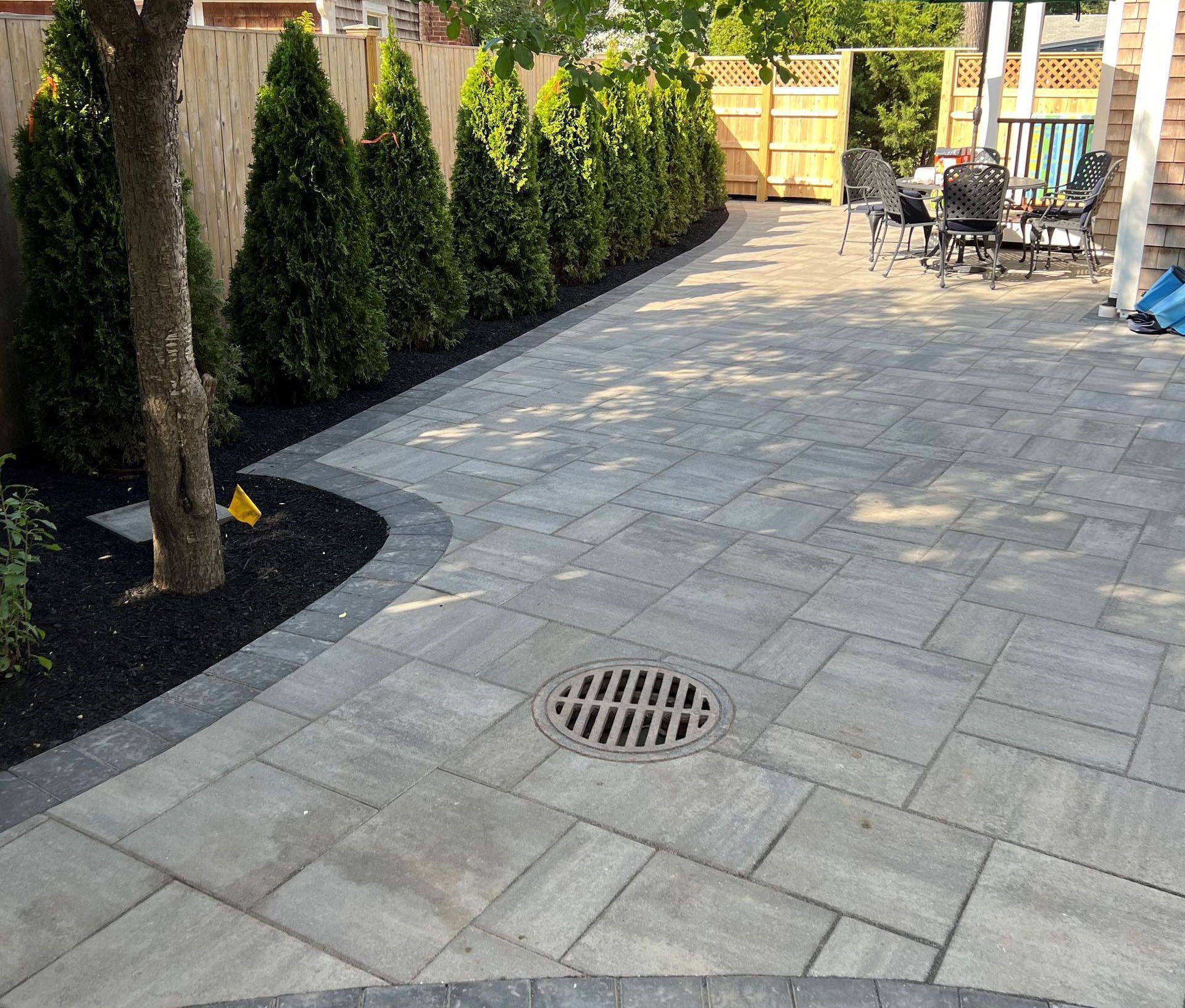 A patio with a drain in the middle of it.