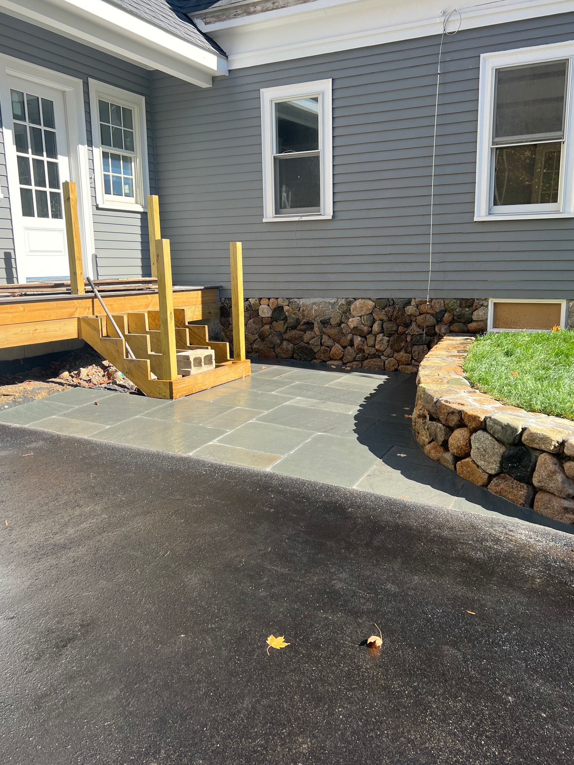 A house with a patio and stairs in front of it