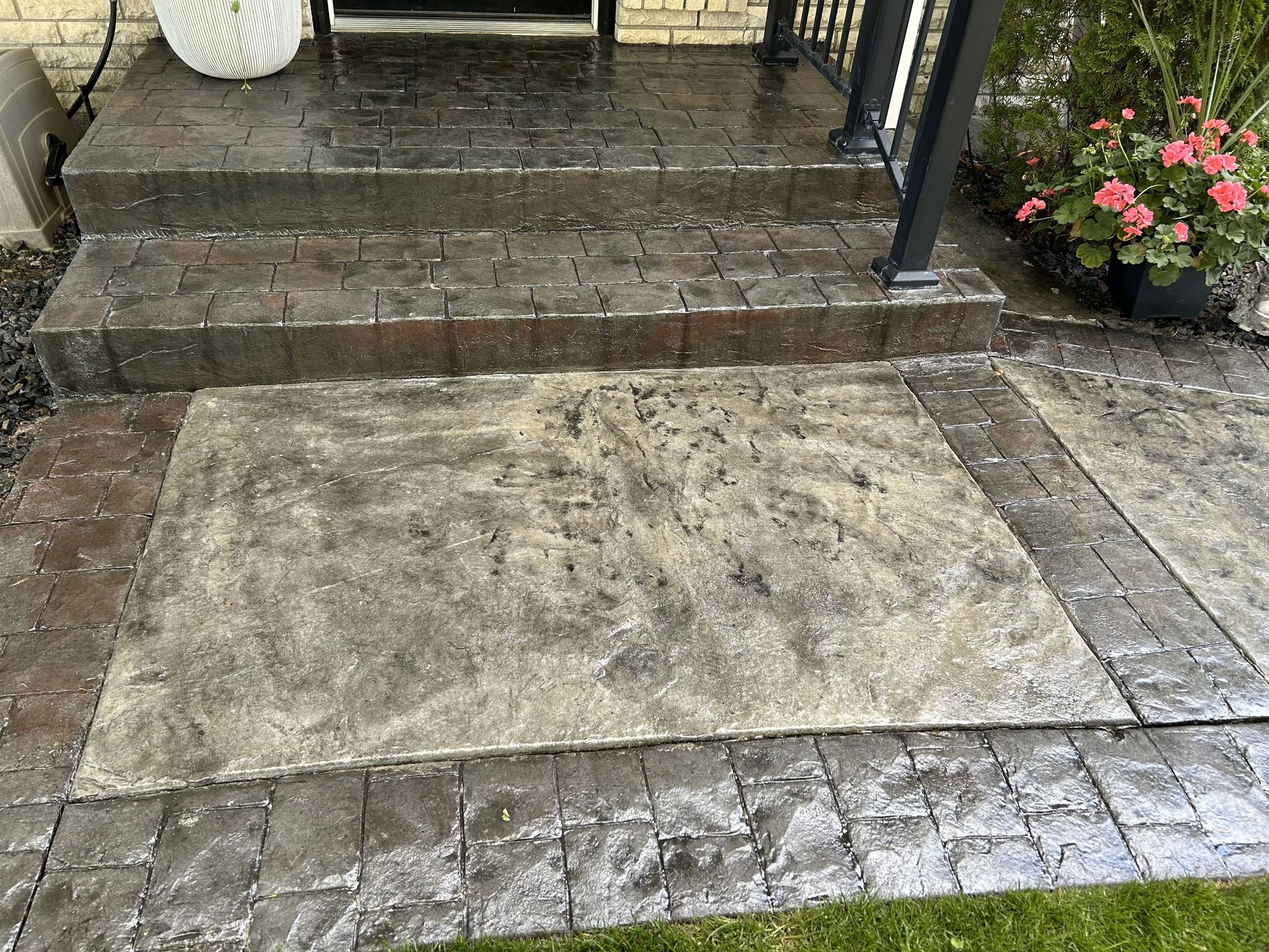 A concrete walkway with steps leading up to a house.