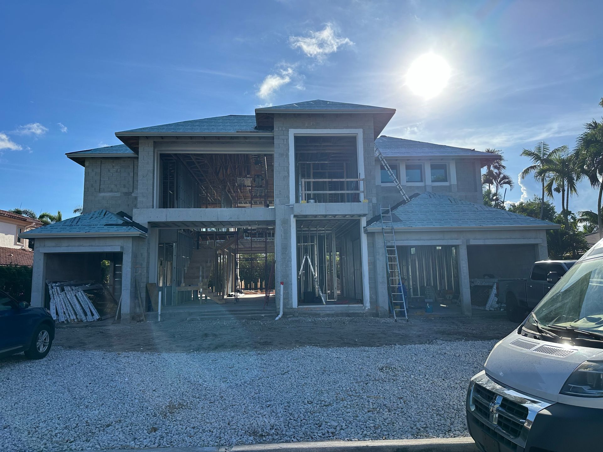 A large white house with palm trees in front of it