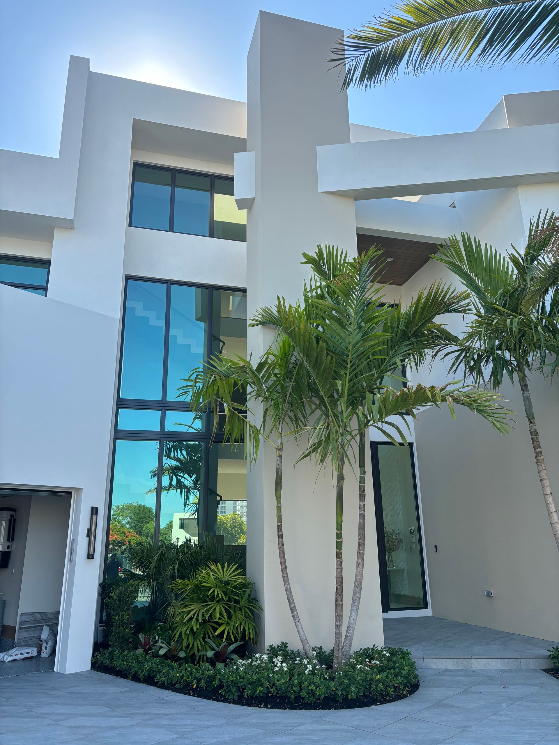 A large white house with palm trees in front of it