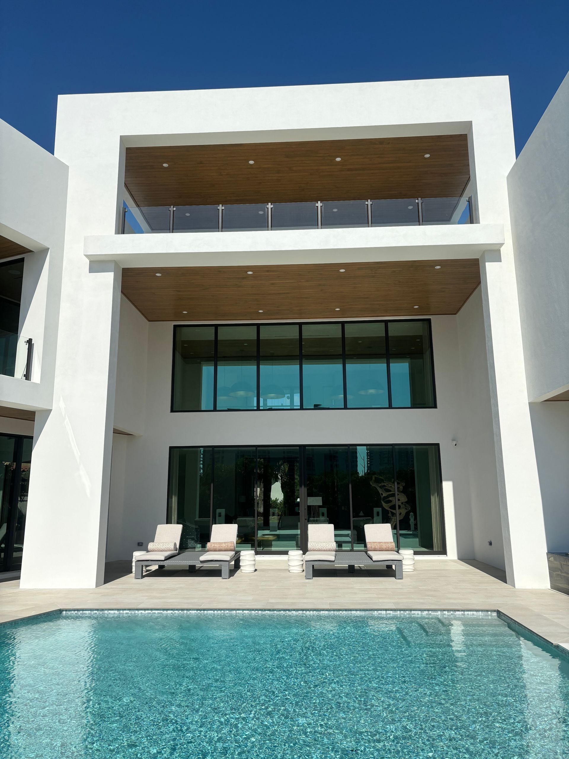 A large white house with a swimming pool in front of it