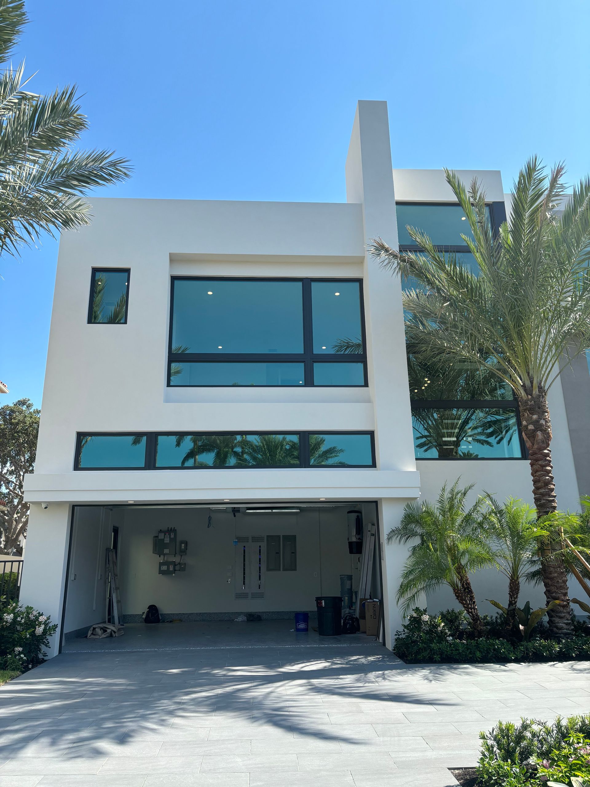 A white house with a garage and a lot of windows