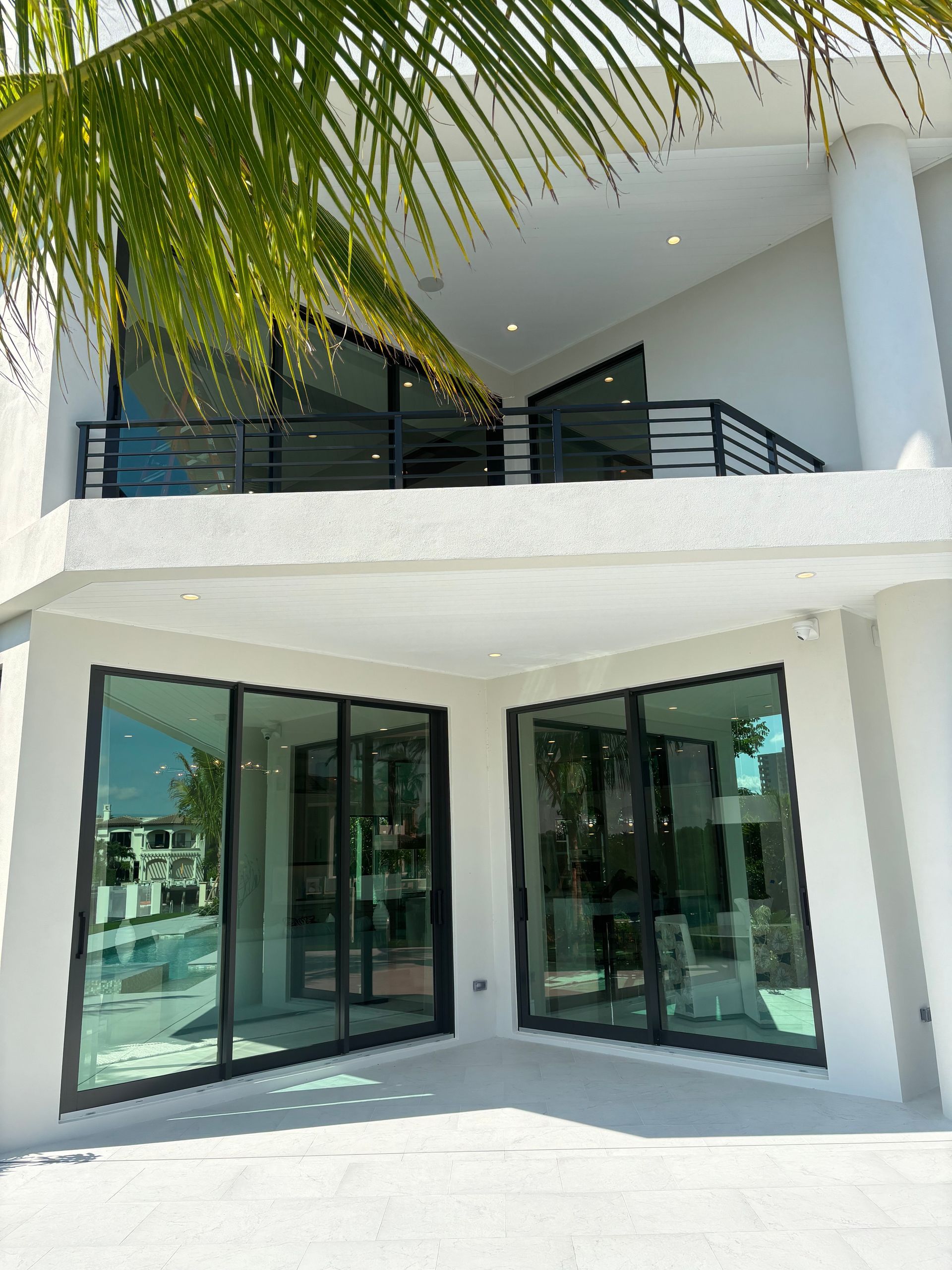 A white house with a balcony and lots of windows