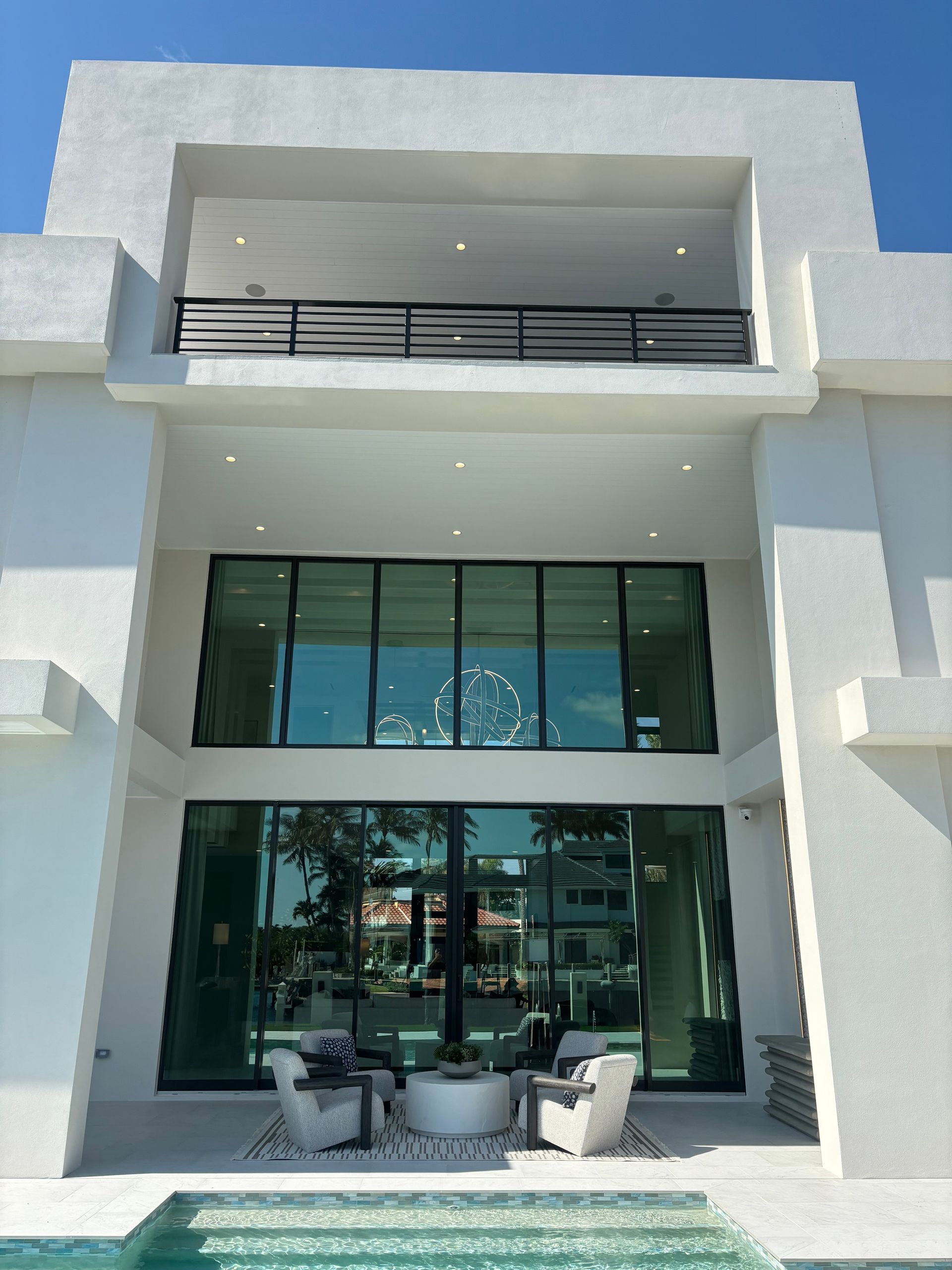 A large white building with a swimming pool in front of it