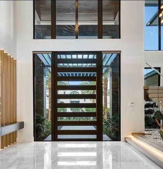 A modern house with a large door and stairs