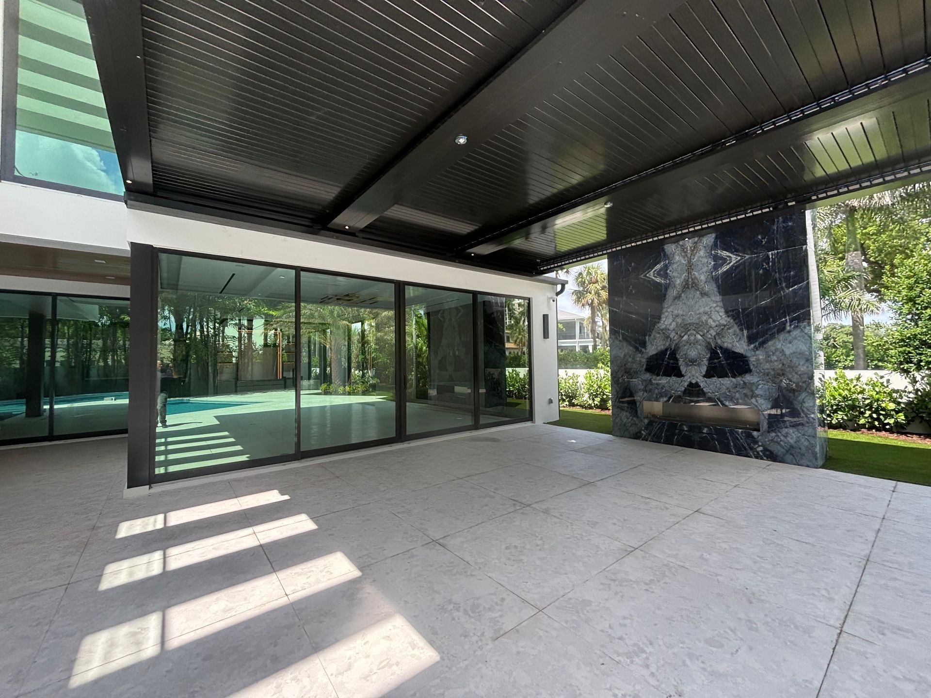 A large building with a lot of windows and a black roof