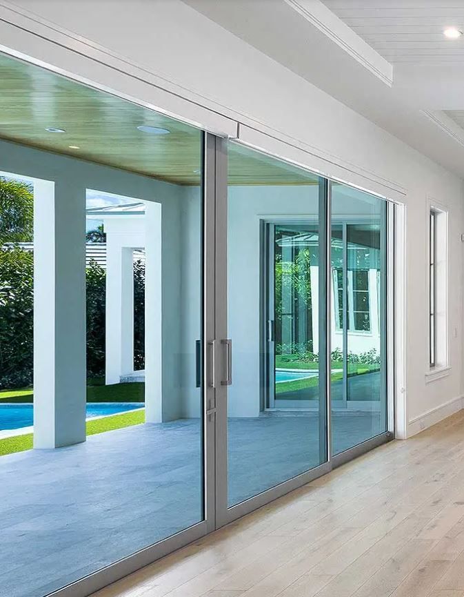 A hallway with sliding glass doors leading to a pool