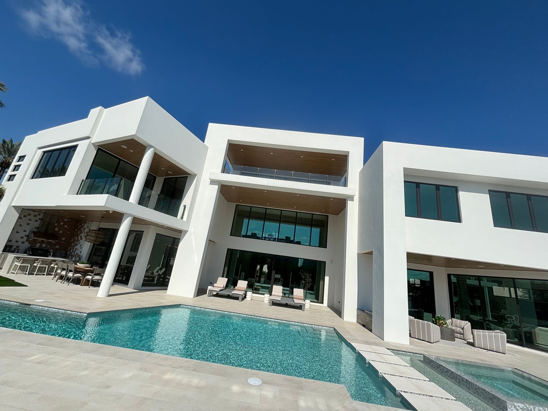 A large white house with a swimming pool in front of it