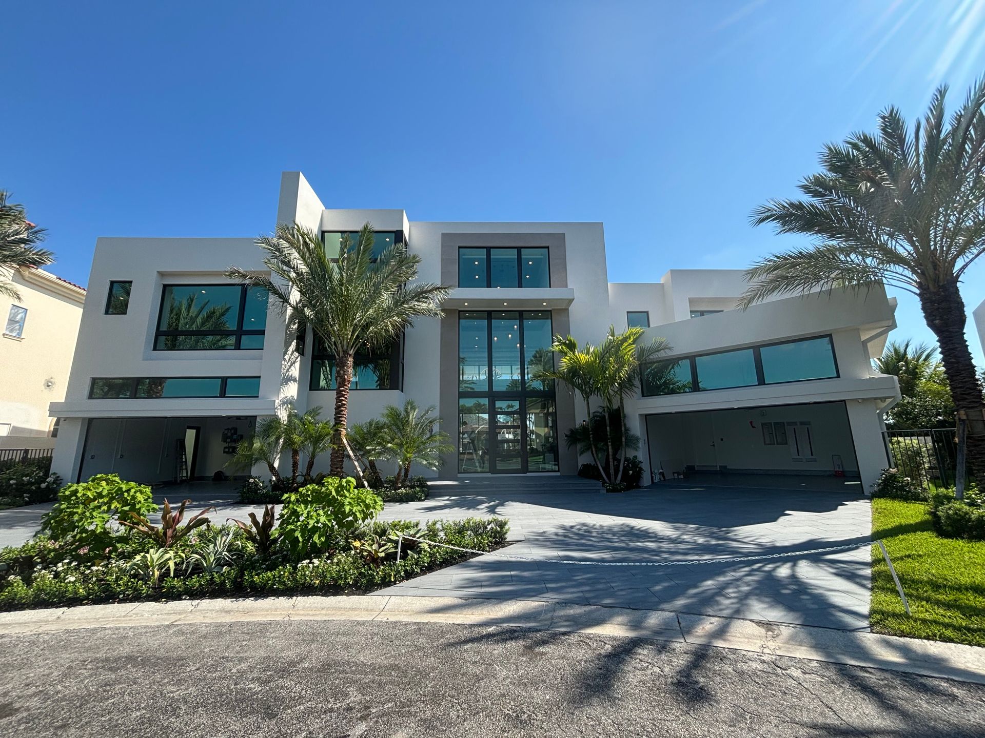 A large white house with palm trees in front of it