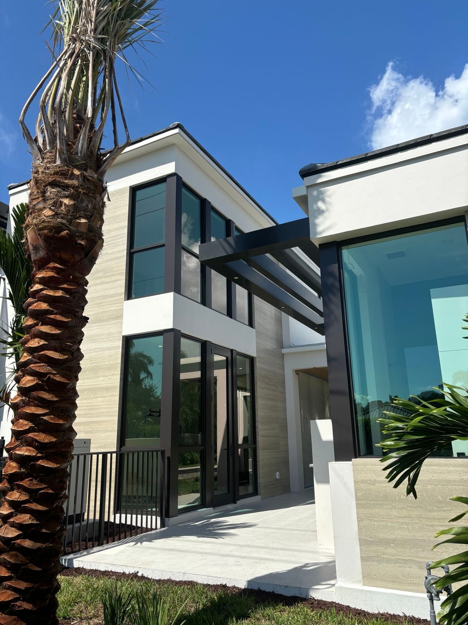 A large house with a palm tree in front of it