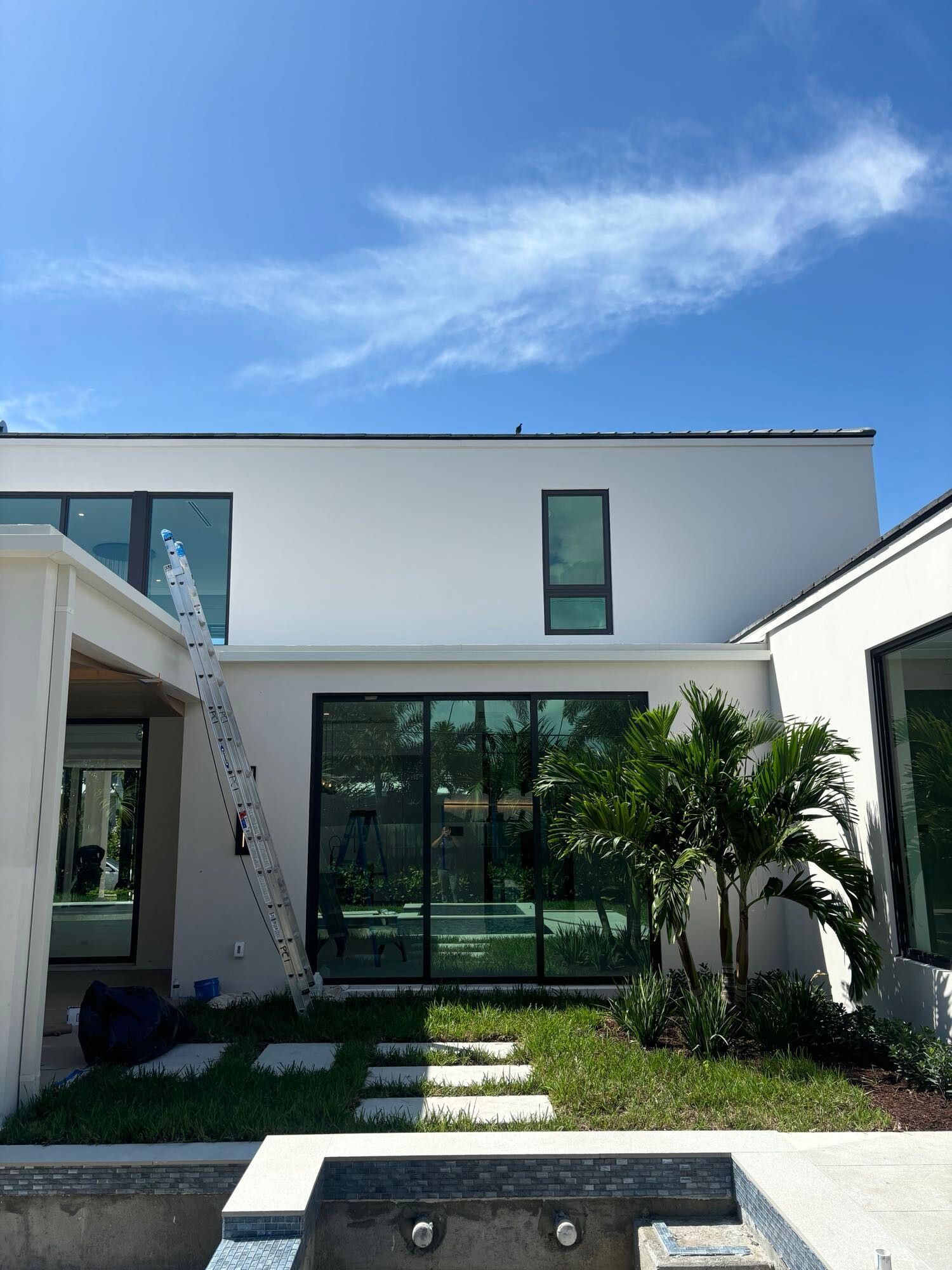 A large white house with a pool in the backyard.