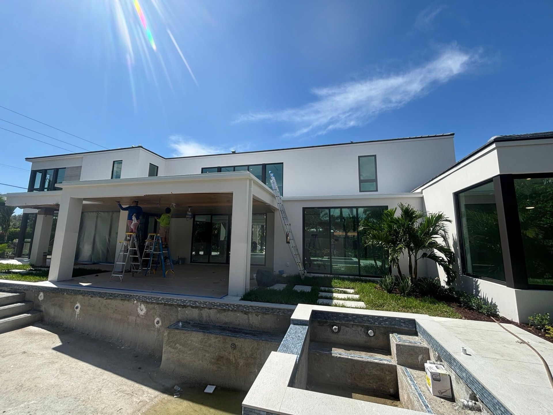 A large white house with a swimming pool in front of it