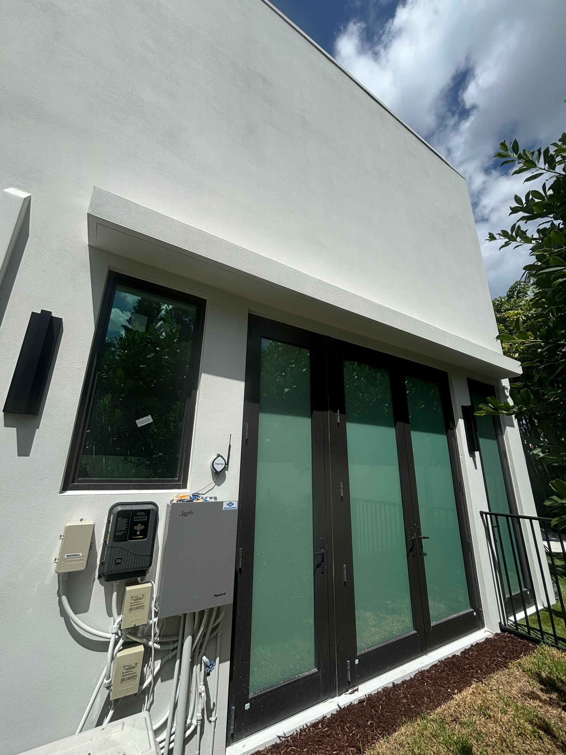 A white building with a lot of windows and doors.