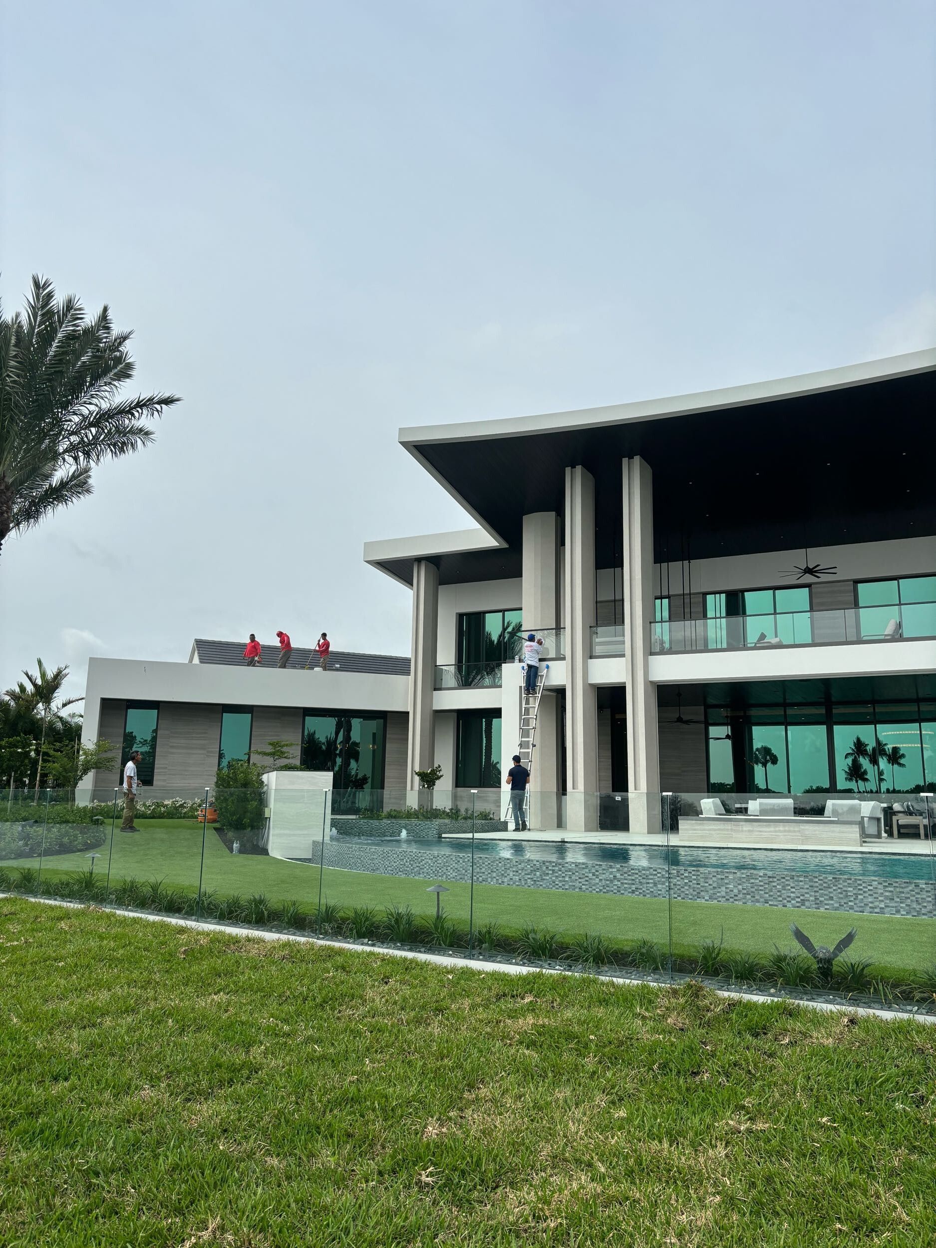 A large house with a swimming pool in front of it.