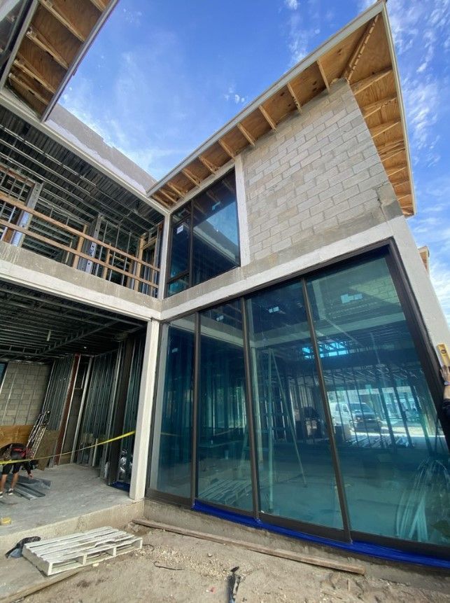 A white truck is parked in front of a large white house.