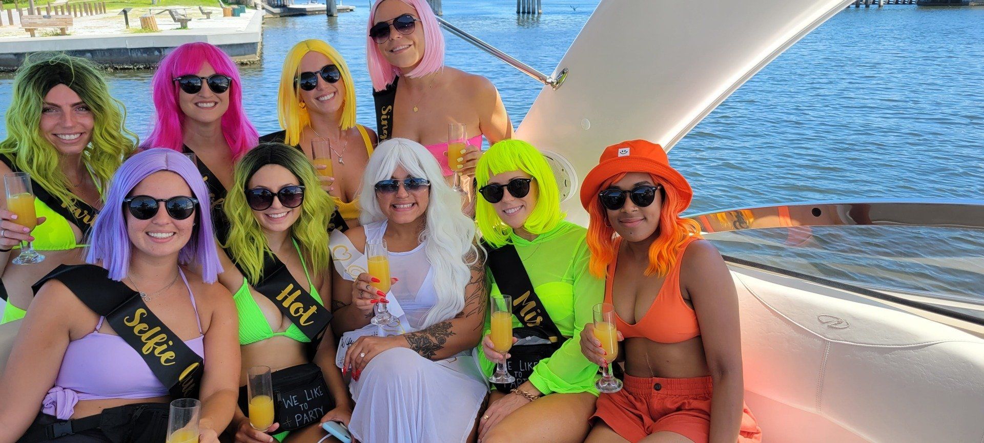 A group of women are posing for a picture on a boat.