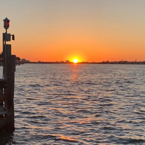 The sun is setting over a body of water