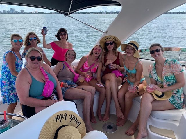 A group of women are sitting on a boat in the water.