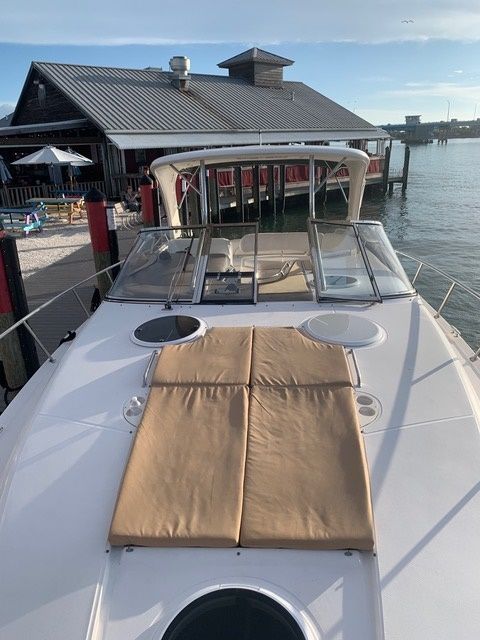 A boat is docked in front of a building in the water.