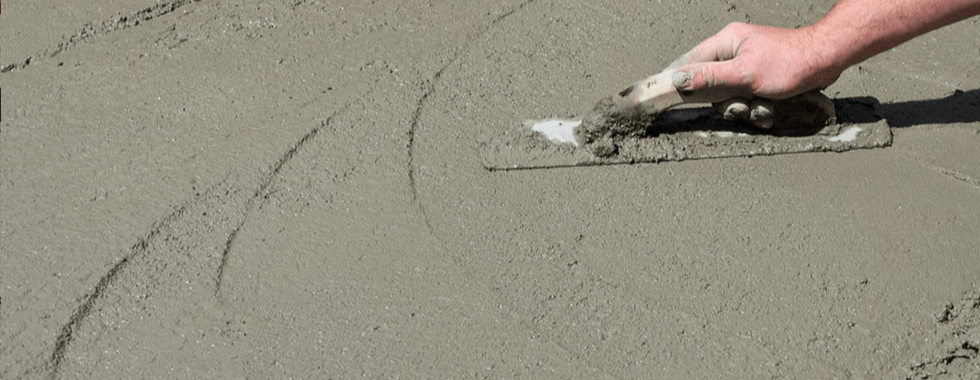 Man using trowel to finish the pavement surface