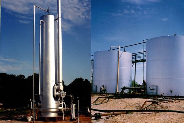 Industrial storage tanks and tall silver tanks at an outdoor facility under a blue sky