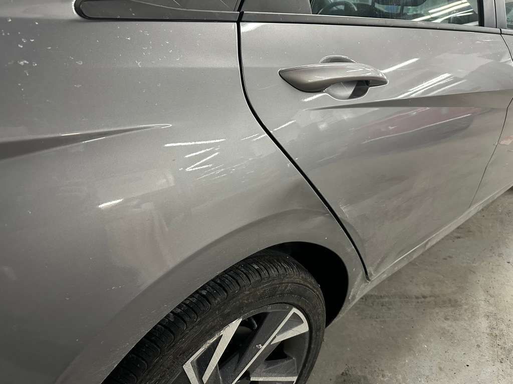 Gray car door and tire.